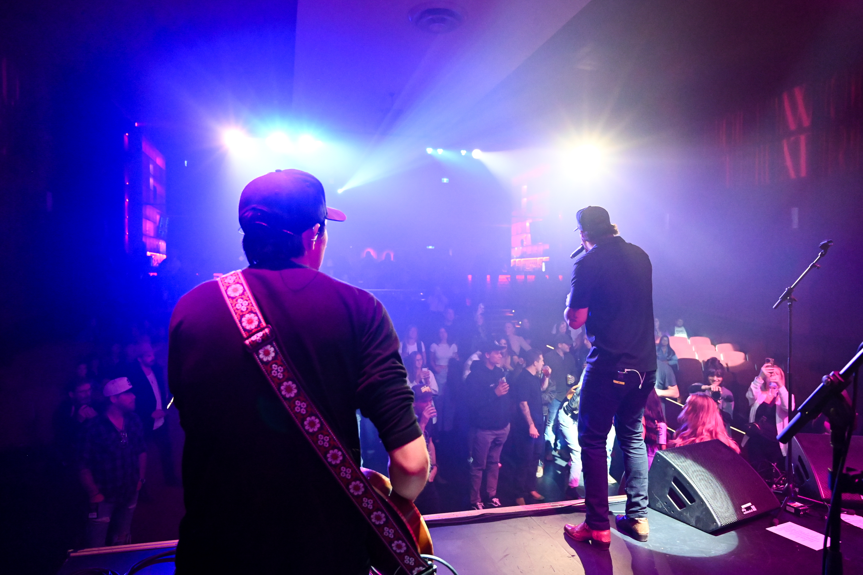 Performers and audience at a live venue in Vancouver